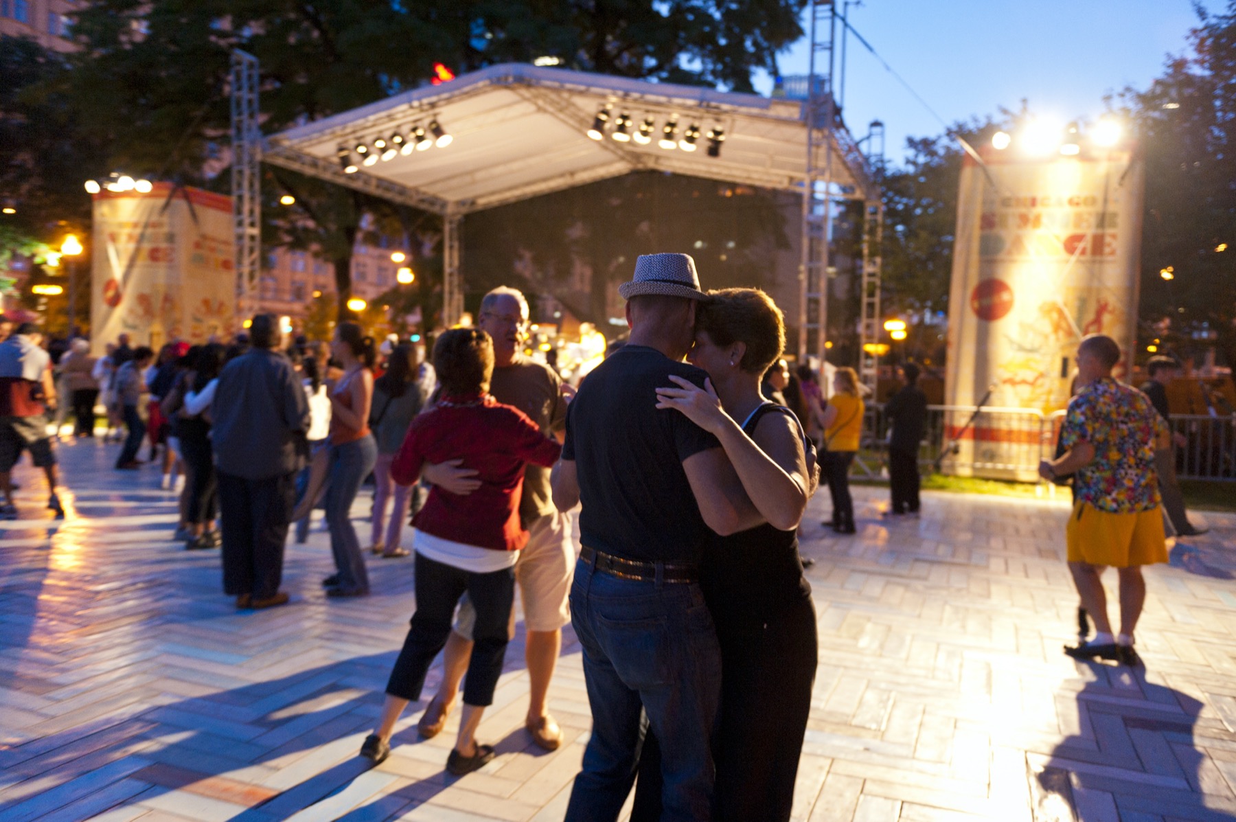 Couples dancing in the park in the evening during Chicago SummerDance, with live music and a romantic open-air atmosphere.