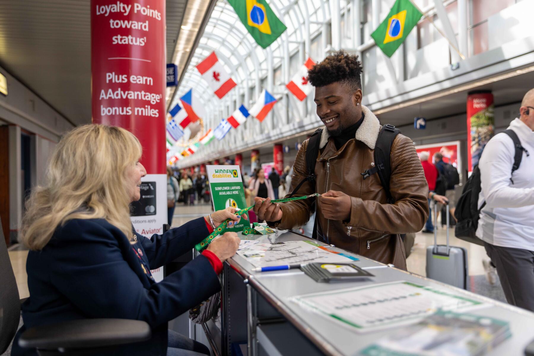 HD Sunflower Lanyard Distribution at an Airport Information Desk